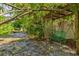 A tranquil backyard setting featuring a bench under a shady trellis, providing a serene outdoor space at 1810 28Th W St, Bradenton, FL 34205