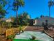 Spacious backyard offers a serene outdoor living space with a palm tree and foliage at 1810 28Th W St, Bradenton, FL 34205