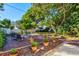 Beautifully landscaped backyard featuring a stone sitting area and lush greenery at 1810 28Th W St, Bradenton, FL 34205