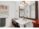 Bathroom features a pedestal sink, dark wood vanity, and a shower/tub combo at 1810 28Th W St, Bradenton, FL 34205