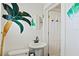 Unique bathroom featuring mosaic tile, a pedestal sink, and a door to a nearby room at 1810 28Th W St, Bradenton, FL 34205