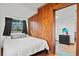 Cozy bedroom with wood paneling and ample natural light from the window at 1810 28Th W St, Bradenton, FL 34205