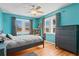 Stylish bedroom with cool-toned walls, modern furnishings and a view to the outside at 1810 28Th W St, Bradenton, FL 34205