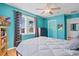 Another view of the stylish bedroom with cool-toned walls, modern furnishings and a view to the outside at 1810 28Th W St, Bradenton, FL 34205
