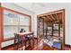A cozy dining area with hardwood floors, a table and chairs, and direct access to a screened-in porch at 1810 28Th W St, Bradenton, FL 34205