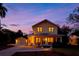 Charming two-story home with inviting front porch and well-manicured lawn at sunset at 1810 28Th W St, Bradenton, FL 34205