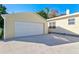 Detached garage with a white double door and light yellow siding at 1810 28Th W St, Bradenton, FL 34205