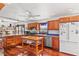 Bright kitchen featuring hardwood floors, cabinets, and stainless appliances, and a breakfast bar with seating at 1810 28Th W St, Bradenton, FL 34205