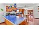 Cozy kitchen with tile countertops, hardwood cabinets and floors, plus stainless appliances and a small dining table at 1810 28Th W St, Bradenton, FL 34205