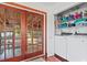 Laundry room with modern washer, dryer, and a view of the outdoor patio through French doors at 1810 28Th W St, Bradenton, FL 34205