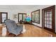 Bright living room features hardwood floors, multiple windows, comfortable seating and entertainment center at 1810 28Th W St, Bradenton, FL 34205