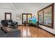 Bright living room features hardwood floors, multiple windows, comfortable seating and entertainment center at 1810 28Th W St, Bradenton, FL 34205