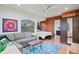 Cozy living room featuring a comfortable sofa, wood accents, and a sunlit bedroom in view at 1810 28Th W St, Bradenton, FL 34205