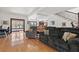 Open concept living room with hardwood floors, comfortable seating and stair access at 1810 28Th W St, Bradenton, FL 34205