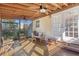 Covered patio with wooden floors and ceiling fans, perfect for outdoor relaxation at 1810 28Th W St, Bradenton, FL 34205