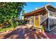 Relaxing screened patio with brick flooring, lush landscaping, and comfortable outdoor seating at 1810 28Th W St, Bradenton, FL 34205