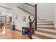 Staircase featuring hardwood steps and dark iron balusters with an adjacent open layout connecting the kitchen at 1810 28Th W St, Bradenton, FL 34205