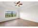 Spacious bedroom with large window and wood floors at 7718 Lake Vista Ct # 405, Lakewood Ranch, FL 34202