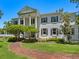 Grand two-story home with columns and brick pathway at 4521 Bay Shore Rd, Sarasota, FL 34234