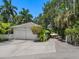 Two-car garage with white exterior and gated entry at 4521 Bay Shore Rd, Sarasota, FL 34234