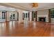 Spacious living room featuring hardwood floors, a fireplace, and access to a waterfront patio at 4521 Bay Shore Rd, Sarasota, FL 34234