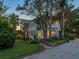 Two-story home with columns and landscaped yard at dusk at 4521 Bay Shore Rd, Sarasota, FL 34234