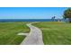 Curving walkway leading to waterfront gazebo with scenic views at 4521 Bay Shore Rd, Sarasota, FL 34234