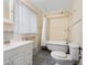 Bathroom with clawfoot tub, shower, toilet and white vanity at 4521 Bay Shore Rd, Sarasota, FL 34234