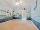 bedroom with ocean mural and neutral carpeting at 4521 Bay Shore Rd, Sarasota, FL 34234