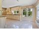Well-appointed kitchen with light cabinets, granite countertops, and tile floors at 4521 Bay Shore Rd, Sarasota, FL 34234