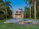 Home with pool and patio area at dusk at 4521 Bay Shore Rd, Sarasota, FL 34234