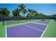 Well-maintained pickleball courts surrounded by lush tropical landscaping at 5920 Midnight Pass Rd # 104, Sarasota, FL 34242