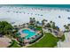 Aerial view of resort community, pool, beach access, and tennis courts at 5920 Midnight Pass Rd # 104, Sarasota, FL 34242
