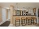 Stainless steel appliances and breakfast bar with modern light fixtures at 5920 Midnight Pass Rd # 104, Sarasota, FL 34242