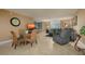 Bright living room with tile floors, comfy seating, and a glass dining table at 5920 Midnight Pass Rd # 104, Sarasota, FL 34242