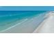 Aerial shot of serene beach and ocean waves at 5920 Midnight Pass Rd # 104, Sarasota, FL 34242
