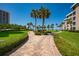 Landscaped grounds with brick walkways leading to beach access at 5920 Midnight Pass Rd # 104, Sarasota, FL 34242