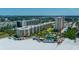 Aerial perspective of beachfront property with pool and lush landscaping at 5920 Midnight Pass Rd # 104, Sarasota, FL 34242