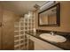 Clean bathroom featuring a glass block shower and granite countertop at 5920 Midnight Pass Rd # 104, Sarasota, FL 34242