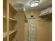 Large closet with shelving, hanging space, and an ironing board at 5920 Midnight Pass Rd # 104, Sarasota, FL 34242