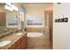 Bathroom features a large soaking tub and walk-in shower at 12624 Richezza Dr, Venice, FL 34293