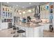 Large kitchen boasts white cabinets, granite island, and high-end stainless steel appliances at 5309 Greenbrook Dr, Sarasota, FL 34238
