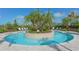 Circular community pool with surrounding lounge chairs and landscaping at 5309 Greenbrook Dr, Sarasota, FL 34238