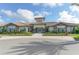 Community clubhouse with attractive landscaping and inviting entrance at 5309 Greenbrook Dr, Sarasota, FL 34238