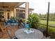 Relaxing screened patio with outdoor dining set and view at 5309 Greenbrook Dr, Sarasota, FL 34238
