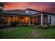 Luxury home with backyard screened patio, lush landscaping, and sunset view at 5309 Greenbrook Dr, Sarasota, FL 34238