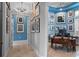 Home office with wood desk, gallery wall, and view of additional rooms at 5309 Greenbrook Dr, Sarasota, FL 34238