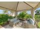 Relaxing covered patio with wicker seating and views of lush landscaping at 5309 Greenbrook Dr, Sarasota, FL 34238