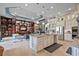 Open concept kitchen with island, stainless steel appliances, and view into living space at 5309 Greenbrook Dr, Sarasota, FL 34238