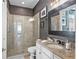 Bathroom with walk-in shower, granite vanity, and neutral tile flooring at 5309 Greenbrook Dr, Sarasota, FL 34238